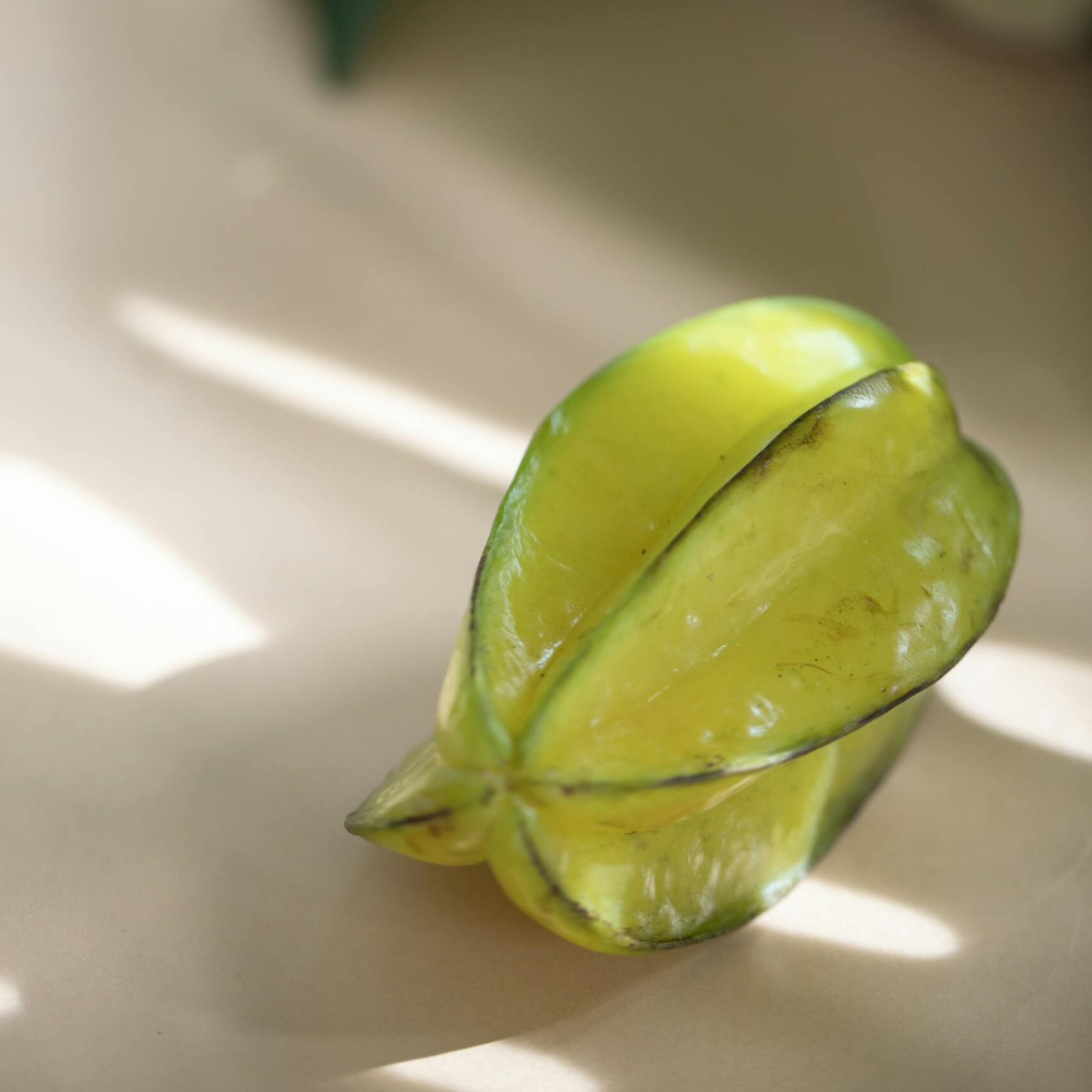 Bright and fresh starfruit in natural lighting, highlighting its tropical appeal and organic texture.