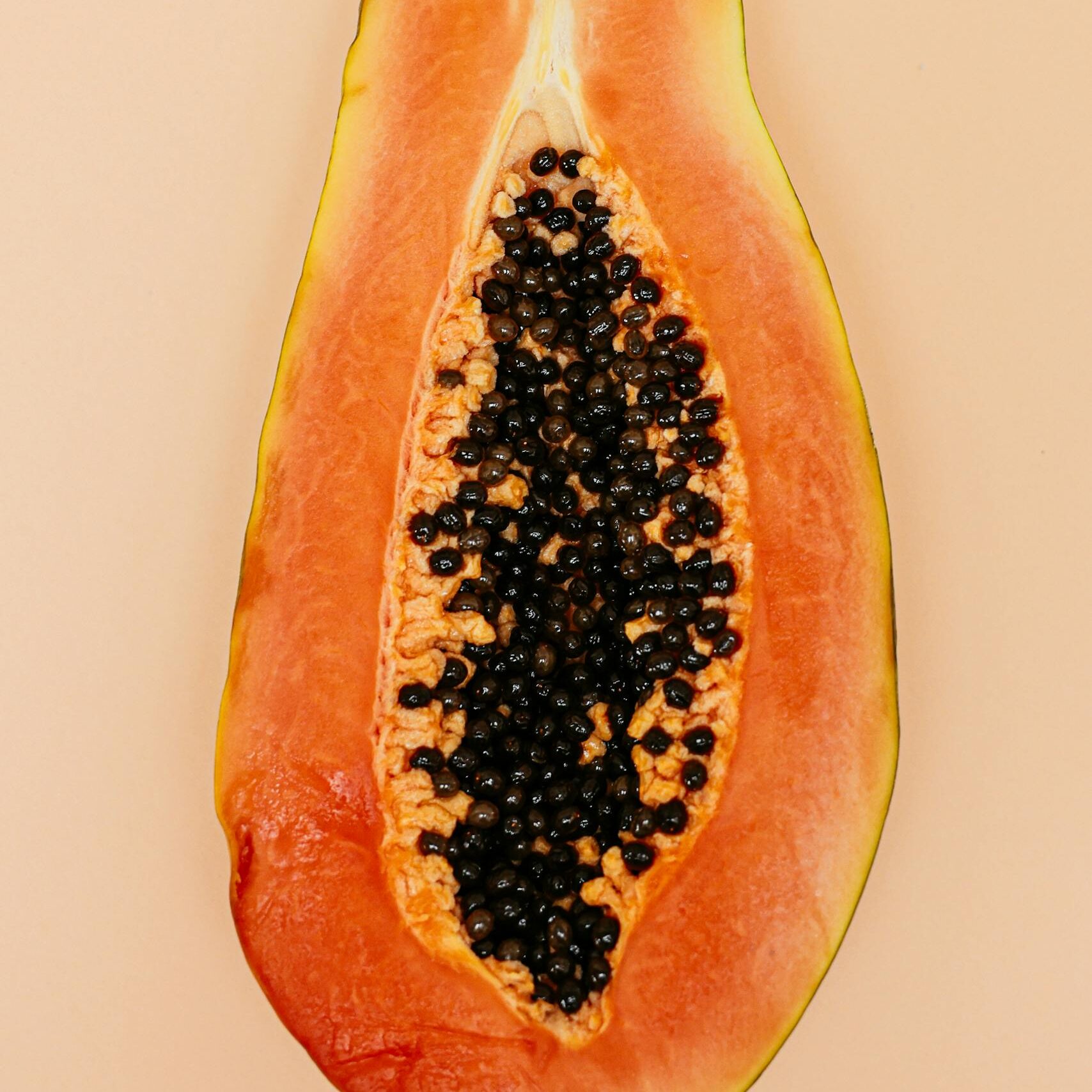 High-quality image of a sliced papaya with visible seeds, perfect for food-related content.